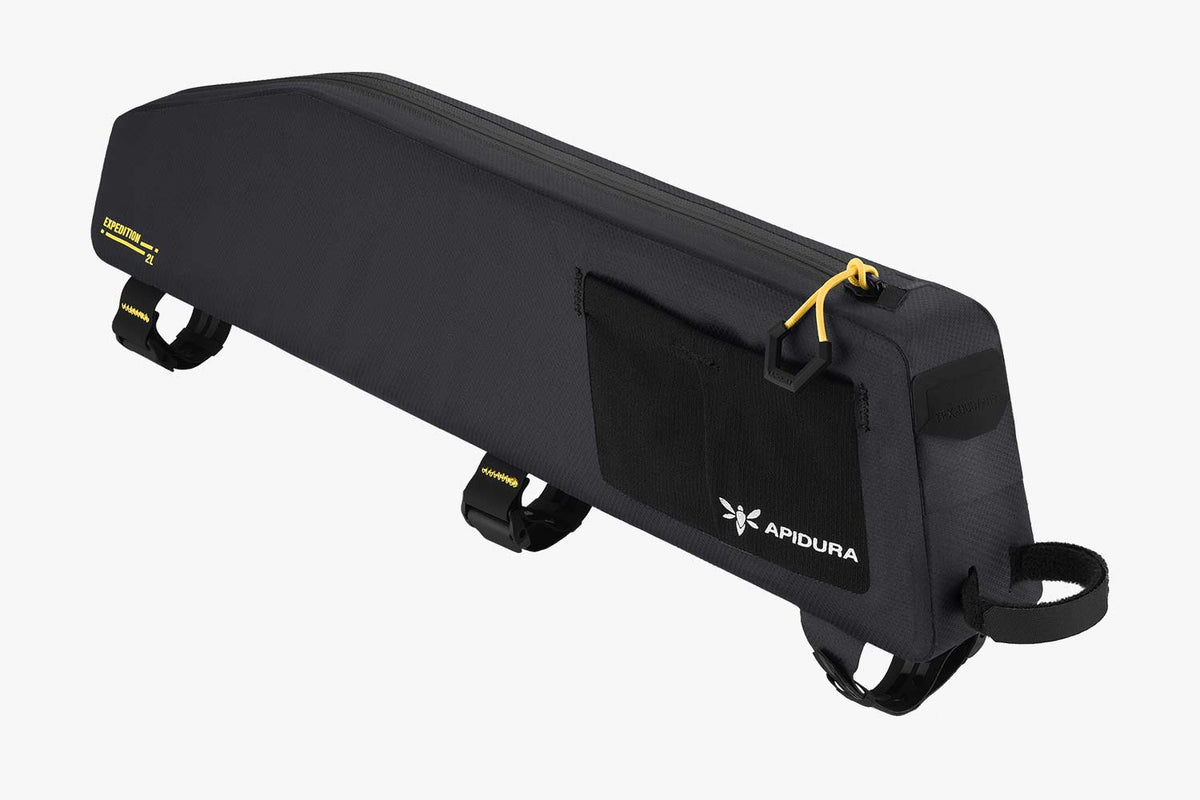 Apidura Expedition Long Top Tube Pack (2L) in black, three-quarter view with side mesh pockets and frame straps